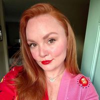 Selfie Rebecca Norris, seu cabelo é separado de um lado. Ela usa batom vermelho.