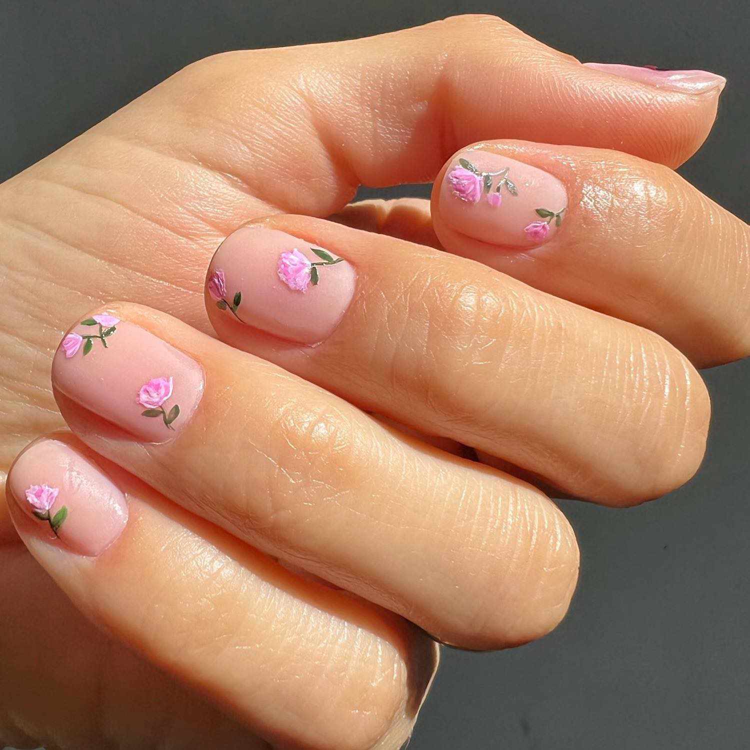 Manicure nude fosca com padrão rosa