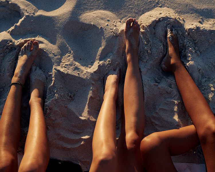 Pernas bronzeadas na praia