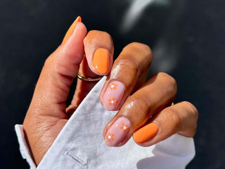 Manicure laranja com detalhes florais laranja